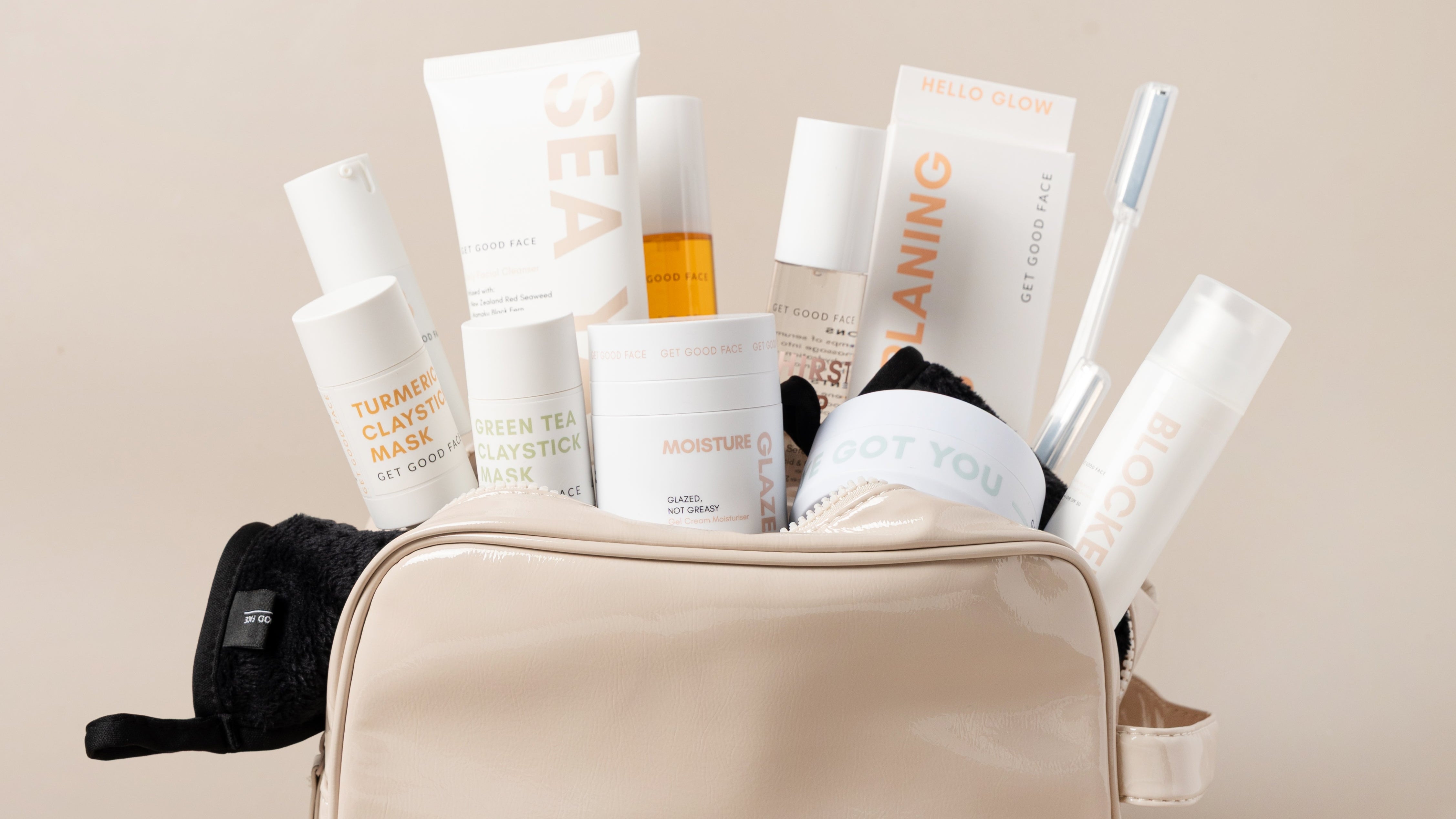 Beige toiletry bag filled with skincare products on a beige background