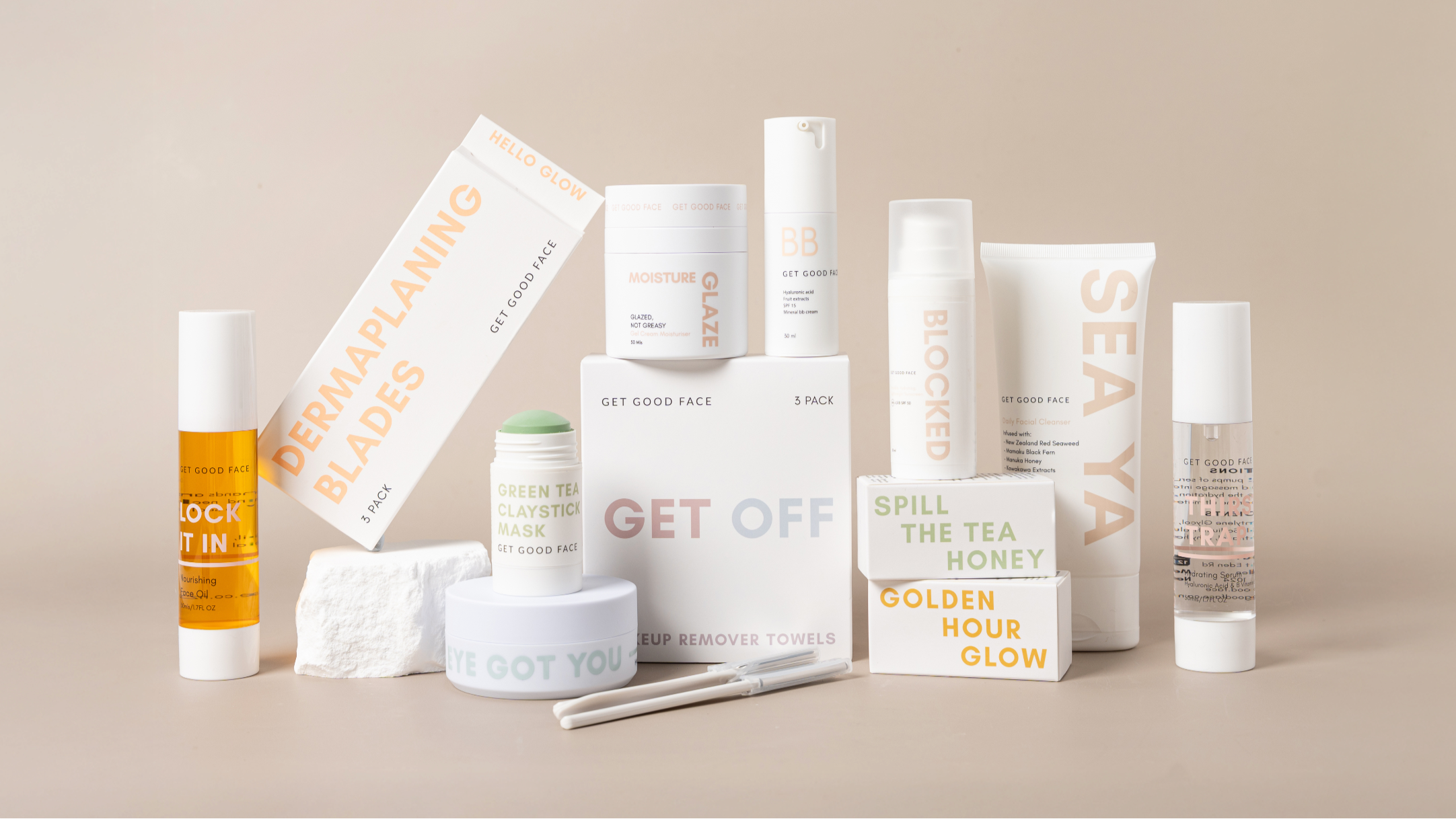 Collection of skincare products with visible brand names on a beige background