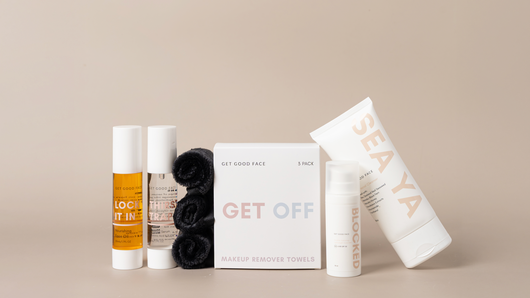 Collection of skincare products from our AM to PM bundle on a beige background